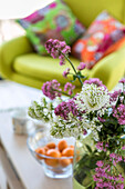 Cut flowers and armchair in Cornwall living room UK