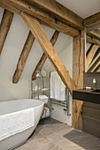 Freestanding bath in timber framed barn conversion Hampshire UK