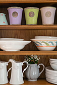 Vases bowls and jugs on wooden dresser in Kent home UK