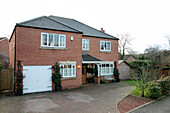 Brick facade driveway and garage of detached Herefordshire home built 2008