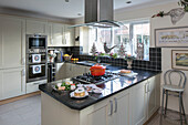 Casserole on kitchen hob units in Bone with black tiled splashback Herefordshire newbuild UK