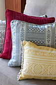 Three patterned cushions on sofa in Kent cottage UK