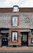 Marineblauer Anstrich mit alter Uhr und Mauerwerk an der Außenseite eines Hauses in Sussex