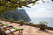 Sunloungers on shaded terrace of Italian villa on the Amalfi coast