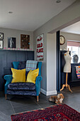 Upcycled blue armchair with yellow cushions in Hampshire home England UK