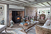 Stone fireplace c1600?s with French coffee table and wooden corner cupboard in Surrey farmhouse UK