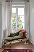Italian Louis XV style chaise longue at French doors in Lot et Garonne chateau France