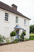 Gravel driveway with Georgian style porch in in West Sussex rectory UK