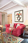 Bright pink sofa with Parrot print in Grade II listed farmhouse Bodmin Cornwall UK