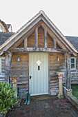 Wooden porch entrance to extension of 1860s Victorian cottage Midhurst West Sussex UK