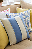 Blue and white striped cushion on sofa in Surrey cottage UK