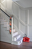White panelled staircase with banister in gloss black London UK