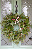 Christmas wreath on front door of Georgian terraced cottage Hampshire UK
