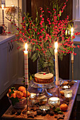 Christmas cake and lit candles in Hampshire cottage kitchen UK
