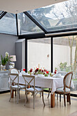 Dining table in conservatory extension of London villa UK