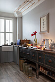 Boot room with butler sink and Georgian shop counter in London home UK
