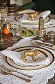 Gold lion ornament on place setting in Grade II listed Georgian country house West Sussex UK