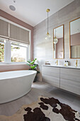 Double basins with mirrors and freestanding bath at window in Victorian villa Tunbridge Wells Kent UK