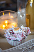 Wrapped sweets in bowl with lit candle on tray in Surrey cottage UK