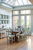 Table for eight with botanic prints in conservatory of Edwardian townhouse Southwest London UK