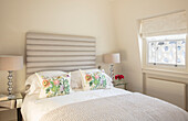 Bedroom detail with upholstered headboard London UK