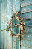 Autumn wreath on weathered outhouse Isle of Wight, UK