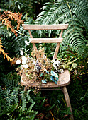 Dried flowers on wooden chair in ferns Isle of Wight, UK