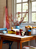 Twig arrangement and jam with apples on kitchen table at window in Isle of Wight home UK