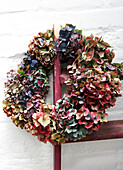 Autumn wreath on whitewashed wall Isle of Wight, UK