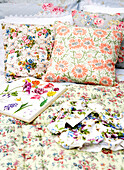 Floral cushions and gardening book in conservatory of Isle of Wight home UK