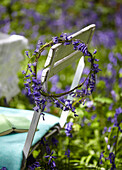 Bluebell garland on chair back in woods