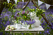 Cut flowers on table in bluebell woods (Hyacinthoides non-scripta)