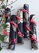 Detail of Christmas crackers tied with ribbon