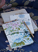 Floral covered notebooks on a sofa