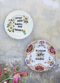 Floral Plates with lettering on distressed wall