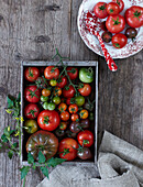 Assorted heirloom tomatoes in a wooden crate