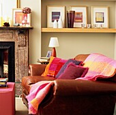 Living room with leather sofa and brightly coloured cushions