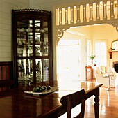 Open plan dining room with wood panel walls and fretwork