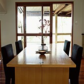 Dining room with table and chairs and view though to terrace