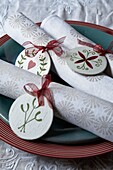 Display of napkins rolled and decorated with Christmas decorations