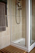Shower cubicle and wooden drying mat