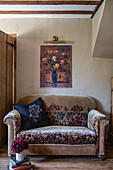 Velvet antique sofa and floral painting
