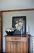 Pine cupboard and vintage floral artwork