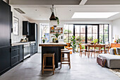 Modern kitchen with island and dining area with a view of the garden