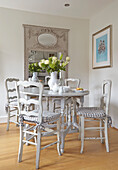 Dining area with country style white wooden table and chairs