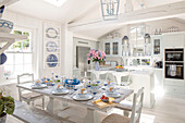 Country-style kitchen with dining table and blue ceramic decorations