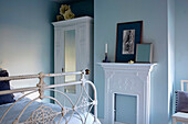 White furniture in a light blue bedroom