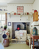 Old wood-burning range in rustic kitchen with vintage ornaments