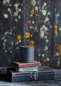 Stack of old metal boxes in front of weathered wooden boards