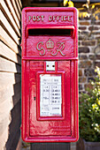 Red English letterbox with initials